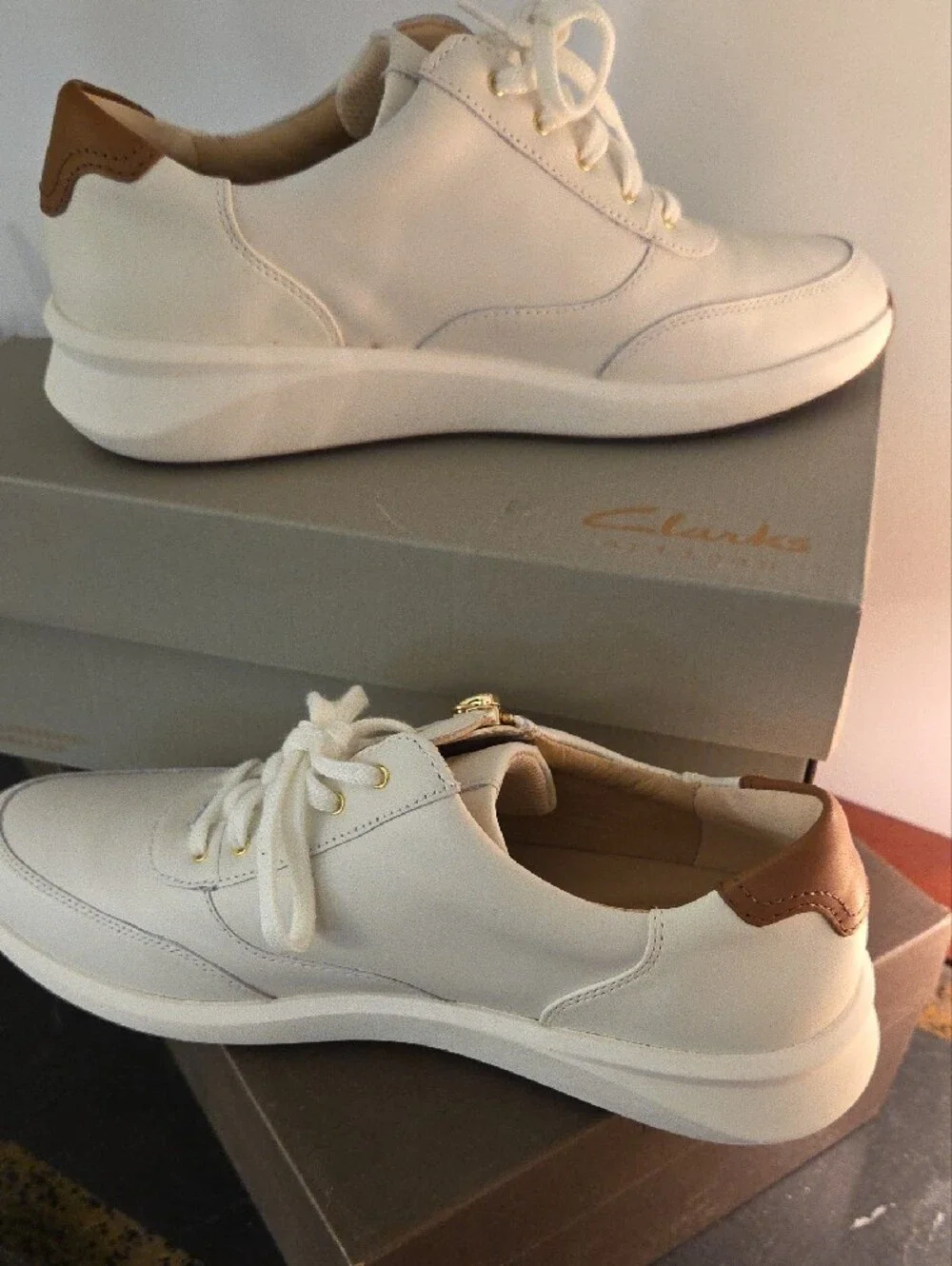 Clarks Cream Leather Sneakers with Brown Heel Accent and Gold Zip